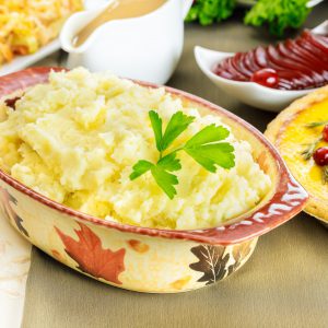 Mashed potatoes on festive dinner table for Thanksgiving Day.