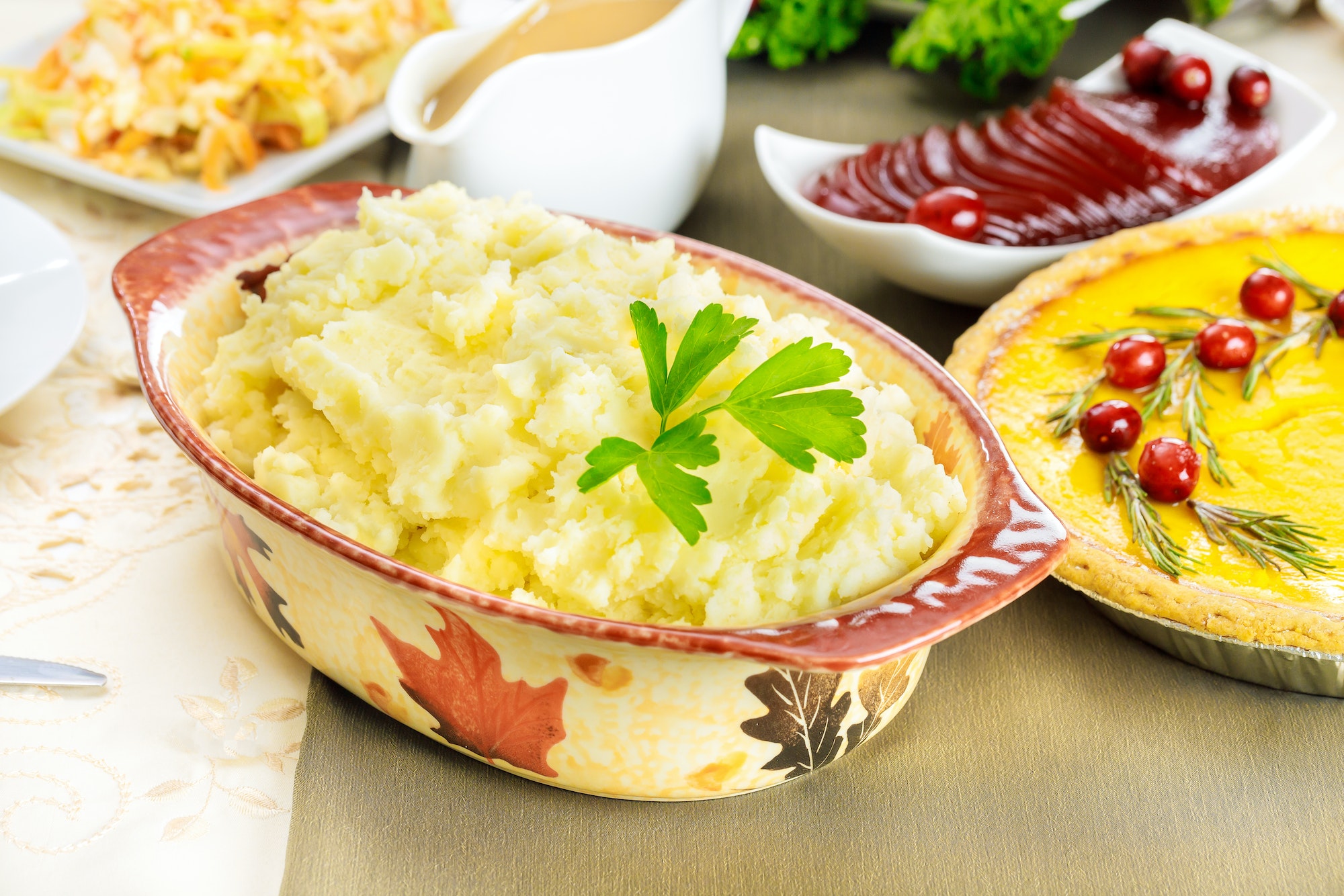 Mashed potatoes on festive dinner table for Thanksgiving Day.