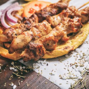 Meat skewers on a wooden background